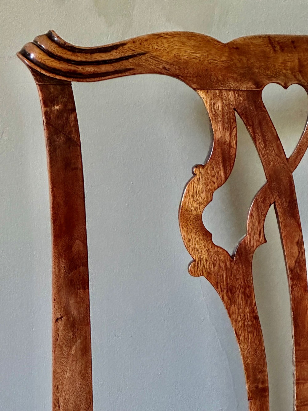 An 18th-century country Chippendale side chair featuring a carved pierced back splat, a square seat upholstered in red fabric, and straight legs joined by stretchers. View III
