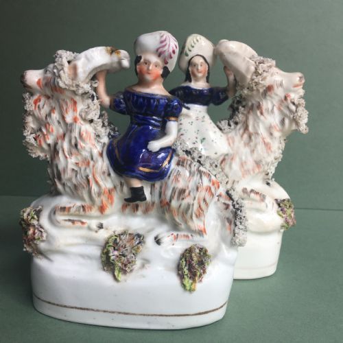 Pair of Figurines portraying Queen Victoria's Oldest Children sitting on Two Very Friendly Goats