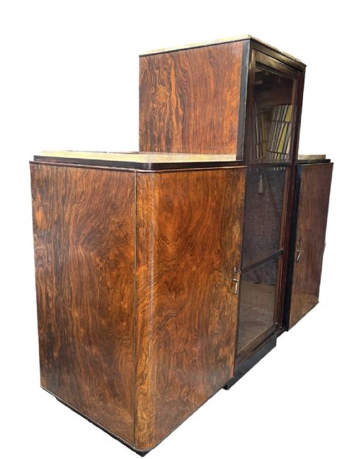 fig 1. An Italian Art Deco tiered cabinet featuring a central glazed compartment, twin side cupboards with figured burr walnut veneer doors, and marble tops.