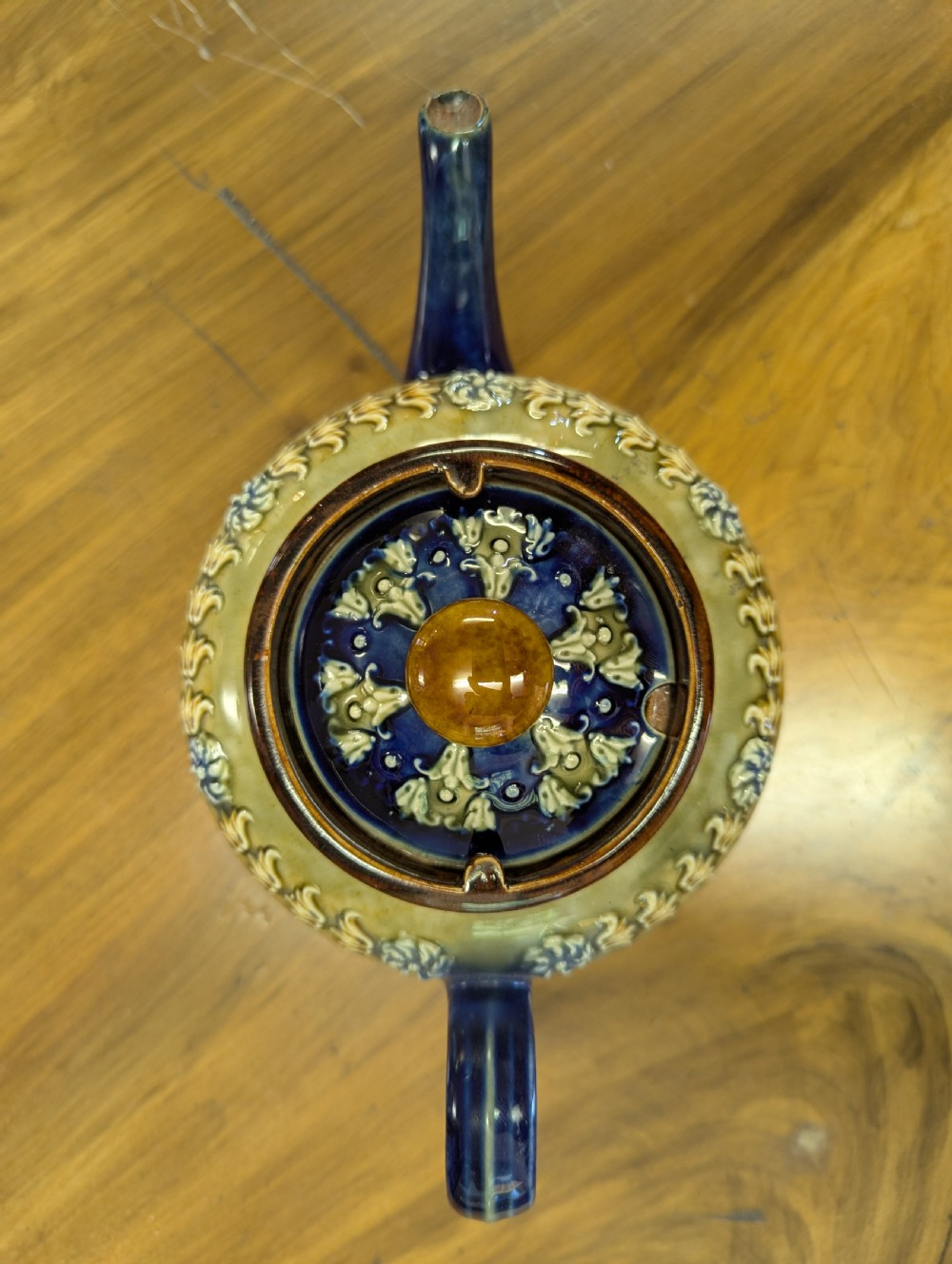 An Art Nouveau Royal Doulton stoneware teapot featuring a cobalt blue base, an olive green shoulder with raised relief patterns, and a fitted lid. View XI