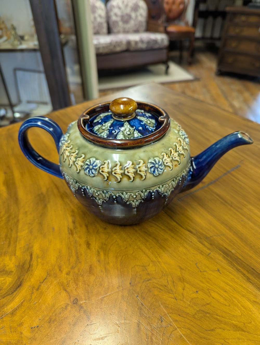 An Art Nouveau Royal Doulton stoneware teapot featuring a cobalt blue base, an olive green shoulder with raised relief patterns, and a fitted lid. View XII