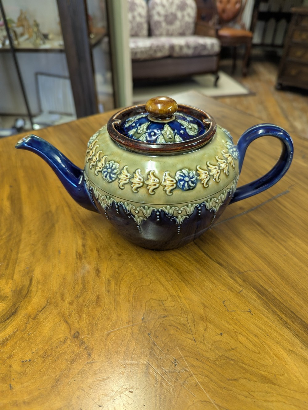 An Art Nouveau Royal Doulton stoneware teapot featuring a cobalt blue base, an olive green shoulder with raised relief patterns, and a fitted lid. View XIII