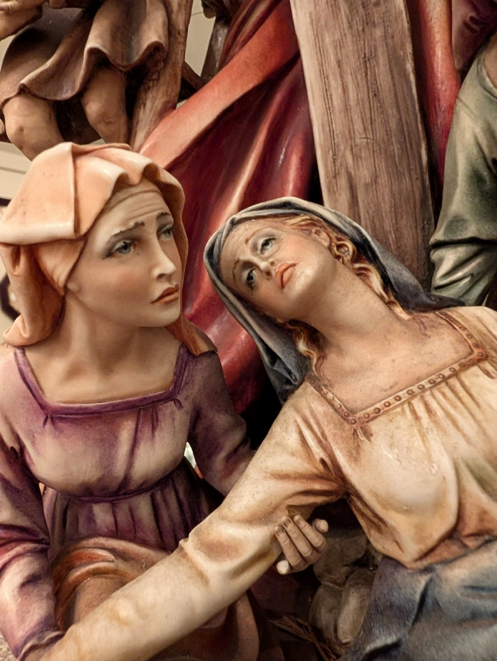 A detailed polychrome porcelain sculpture by Antonio Borsato depicting the Descent from the Cross with multiple hand-painted figures. View III