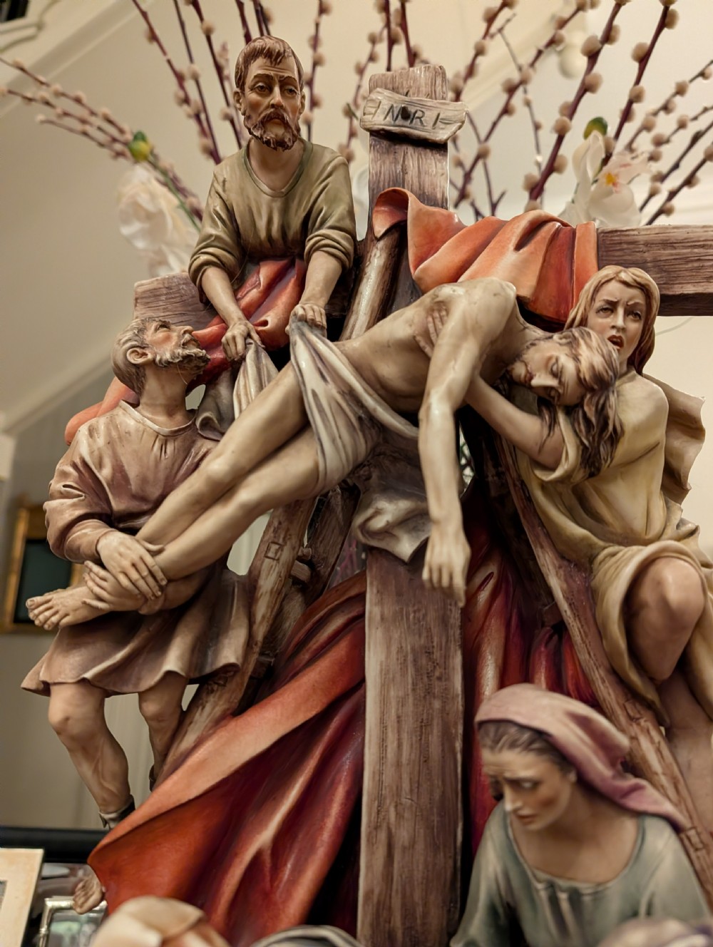 A detailed polychrome porcelain sculpture by Antonio Borsato depicting the Descent from the Cross with multiple hand-painted figures. View V