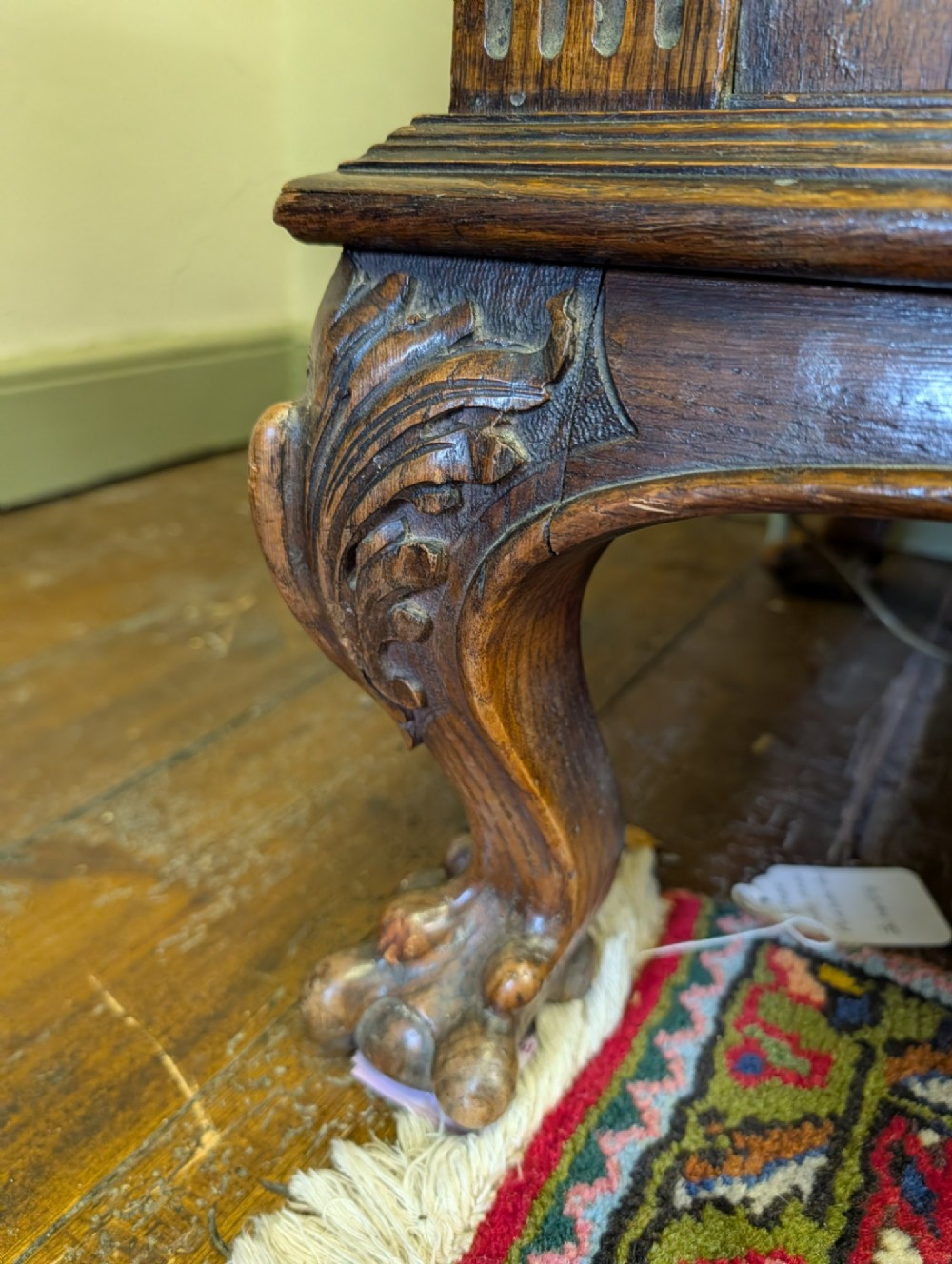 A late Victorian carved oak buffet featuring two top drawers with brass drop handles, an open tier, and a lower double-door cabinet decorated with detailed carved foliage. View XI