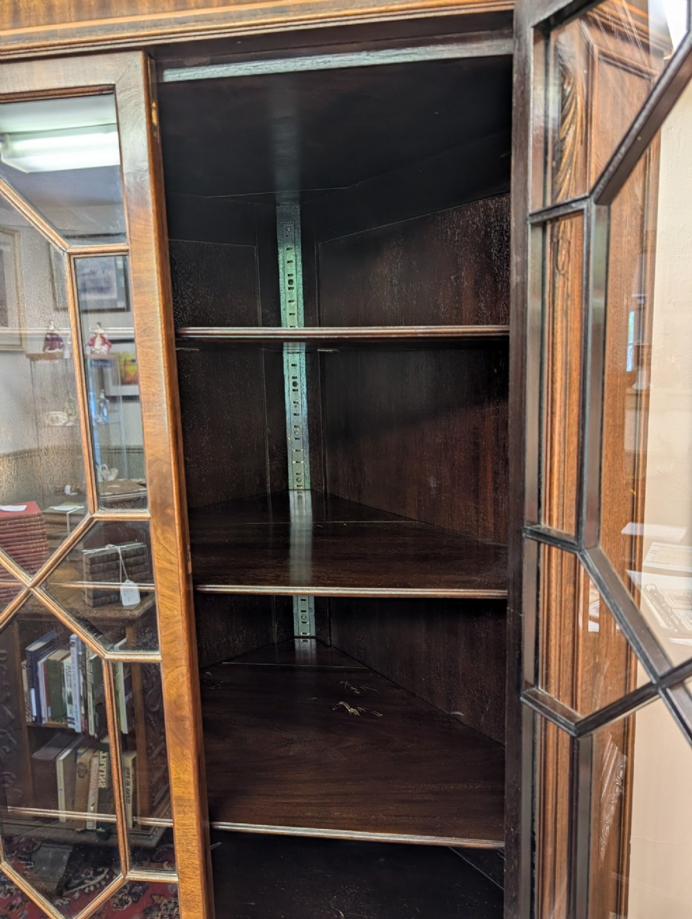 An Edwardian mahogany corner display cabinet featuring a swan-neck pediment, astragal glazed top doors, and lower inlaid timber panelled doors. View VII