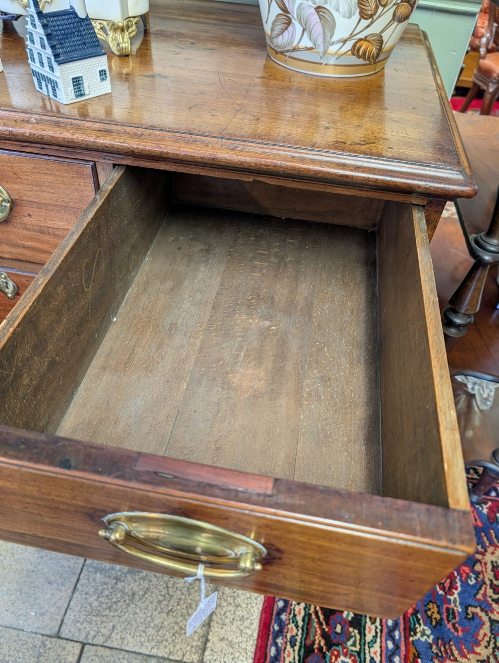 A Georgian mahogany chest of drawers featuring three small upper drawers over three long graduated drawers with brass handles. View III