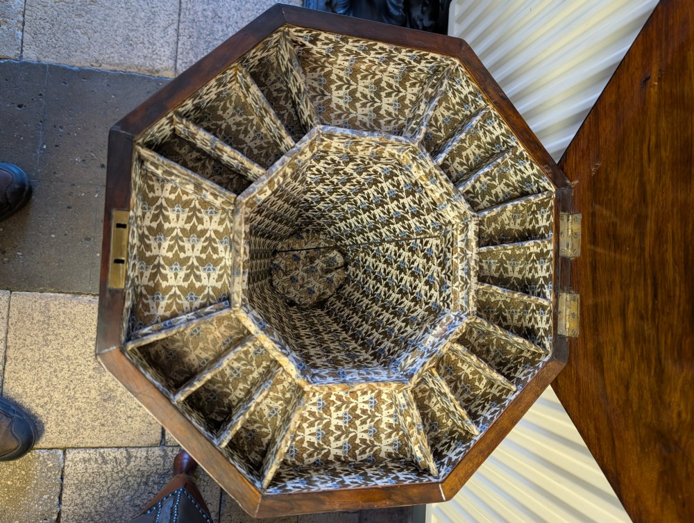 A Victorian octagonal walnut games table featuring an inlaid chessboard lid above a tapering trumpet pedestal on carved tripod legs. View III