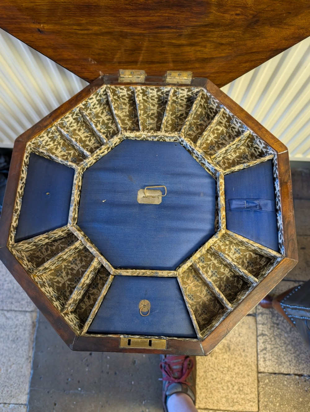 A Victorian octagonal walnut games table featuring an inlaid chessboard lid above a tapering trumpet pedestal on carved tripod legs. View IV