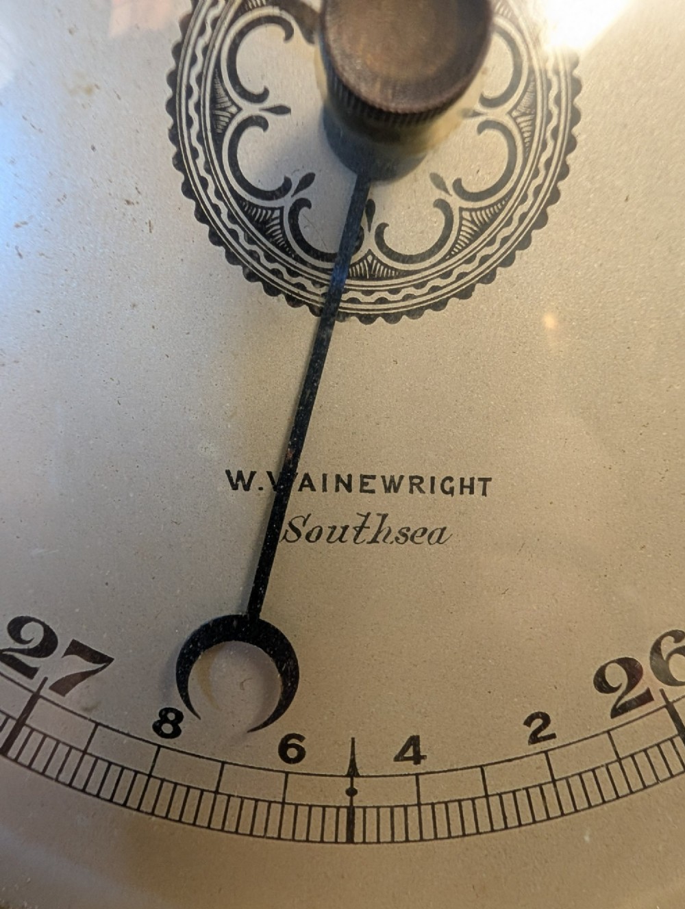 An Edwardian wall-mounted rosewood barometer featuring floral marquetry inlay, a top-mounted glass thermometer, and a circular brass-rimmed pressure dial. View IX