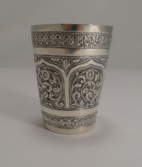 fig 1. An antique Anglo-Indian sterling silver beaker featuring raised repousse floral motifs and decorative arch borders.