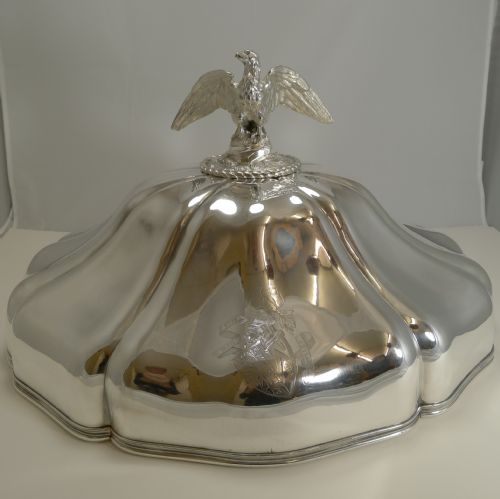 fig 2. A set of three graduated silver meat domes with lobed bodies and detailed eagle finials.