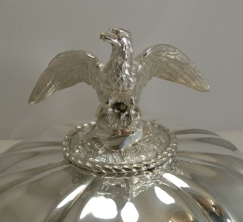 fig 3. A set of three graduated silver meat domes with lobed bodies and detailed eagle finials.