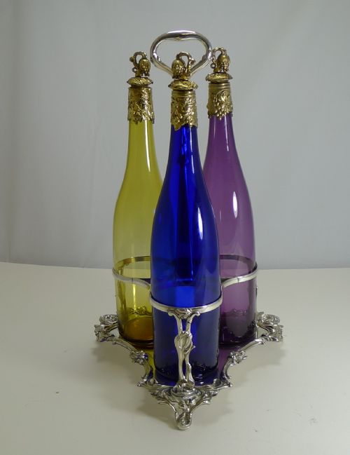 Three Victorian Coloured Glass Decanters in Stand C.1890