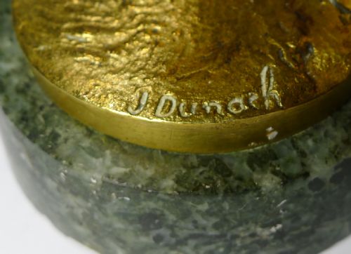 fig 1. A gilt bronze Art Deco sculpture depicting a lady golfer mid-swing mounted on a circular green marble base.
