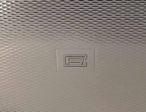 fig 3. A rectangular sterling silver box with a fine engine-turned geometric pattern and a central engraved monogram.