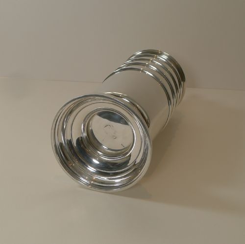 fig 3. A tall, polished sterling silver cocktail shaker featuring horizontal ribbed banding, a stepped base, and a decorative finial cap.