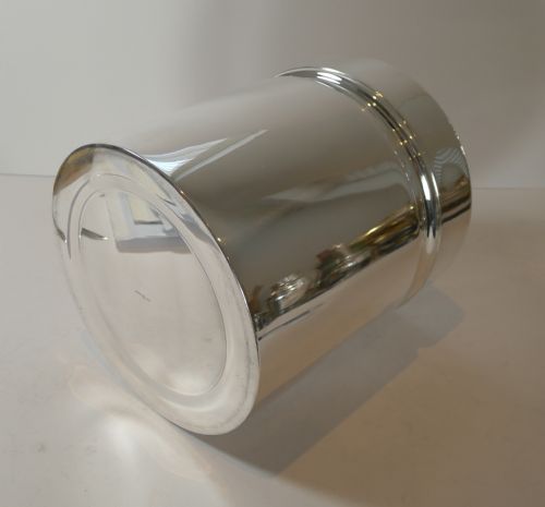 fig 2. A polished silver-plated cylindrical wine cooler featuring a thick double-walled rim and smooth metallic surface.