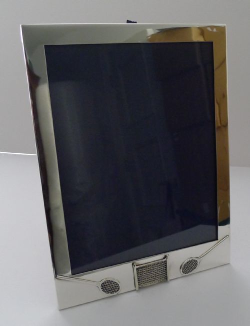 fig 1. A rectangular sterling silver picture frame featuring miniature relief tennis rackets and a net motif at the bottom edge.
