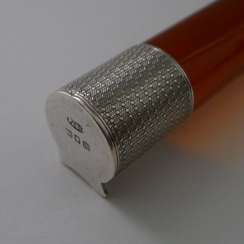 fig 1. A cylindrical amber glass ruler with textured sterling silver caps fitted to each end.