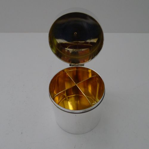 fig 2. A vintage sterling silver smoking compendium set featuring four horseshoe-shaped ashtrays and a central cylinder within an open silk-lined presentation case.
