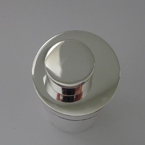 fig 2. A sleek, highly polished cylindrical silver-plated cocktail shaker with an angled upper seam and fitted cylindrical cap.