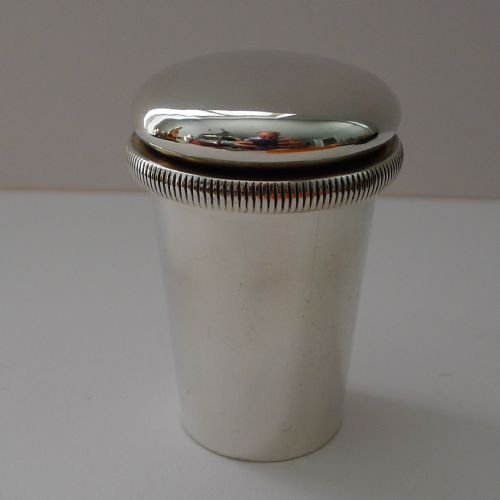 fig 1. An Edwardian sterling silver travelling medical kit featuring a silver outer sleeve, etched glass dose beaker, and gilded screw caps.