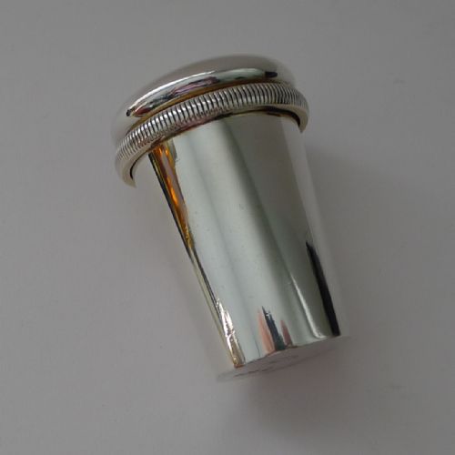 fig 4. An Edwardian sterling silver travelling medical kit featuring a silver outer sleeve, etched glass dose beaker, and gilded screw caps.