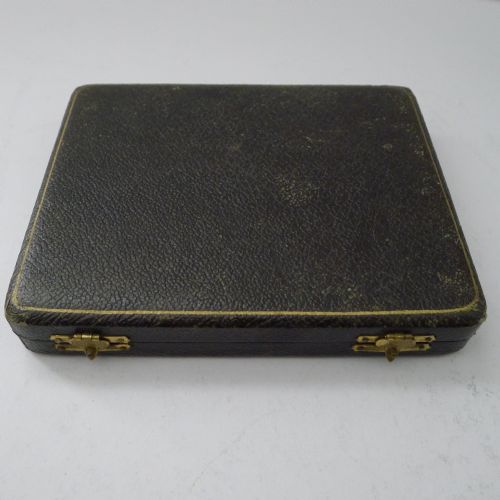 fig 1. A set of six silver-plated lobster picks arranged in a dark velvet-lined presentation case with a cream silk lid.