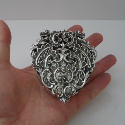 fig 1. A heart-shaped sterling silver pot pourri box featuring intricate pierced scrollwork and foliage motifs across the lid.