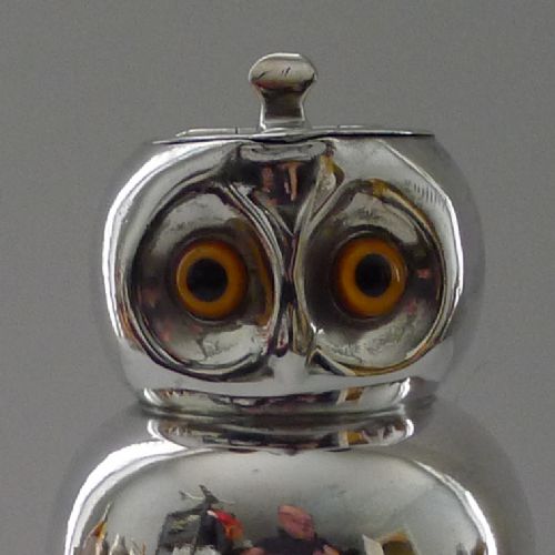 fig 1. An Edwardian silver-plated jug shaped as an owl with inset yellow and black glass eyes and a hinged lid.