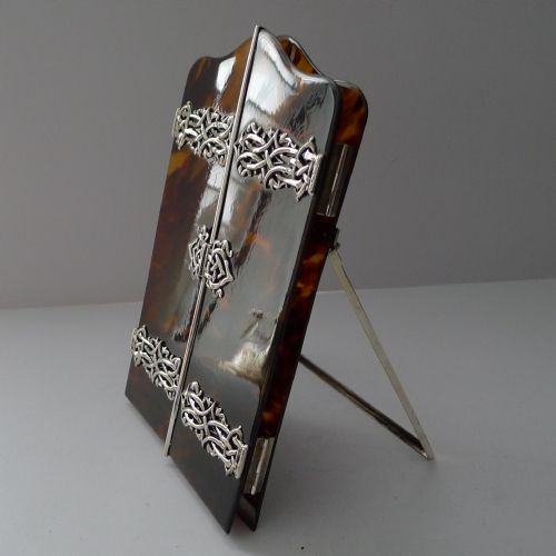 fig 2. A late 19th-century Victorian tortoiseshell photograph frame featuring arched folding doors, pierced sterling silver mounts, and a silver easel back.