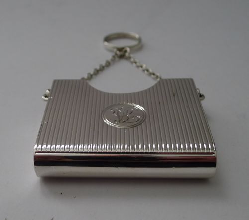 fig 1. A late Victorian sterling silver prayer book holder featuring vertical reeded decoration, an engraved monogram roundel, and a suspension chain with a finger ring.