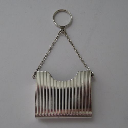 fig 3. A late Victorian sterling silver prayer book holder featuring vertical reeded decoration, an engraved monogram roundel, and a suspension chain with a finger ring.