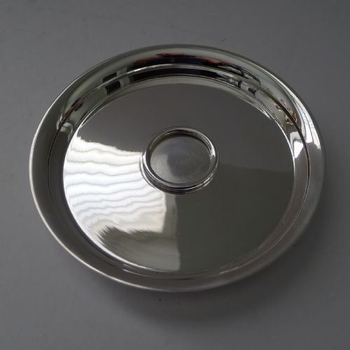 fig 1. A circular polished silver dish featuring a sculpted equestrian horse head handle at the centre.