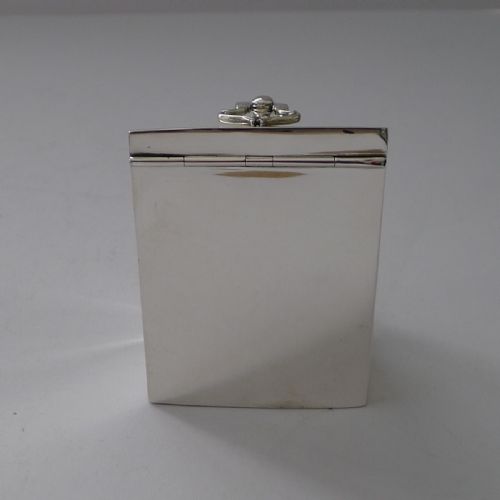 fig 2. A polished sterling silver tea caddy designed in the form of a Georgian knife box with a sloped hinged lid and cast loop handle.