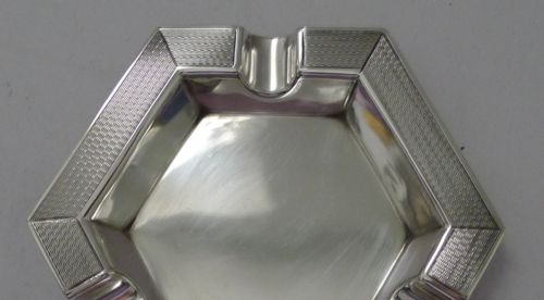 fig 1. An Edwardian hexagonal sterling silver ashtray featuring engine-turned geometric textured rims and cigarette rests.
