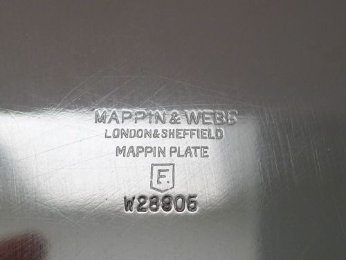 fig 2. A circular silver-plated Art Deco cocktail tray featuring concentric line engraving on the flat surface and two stylized side handles.