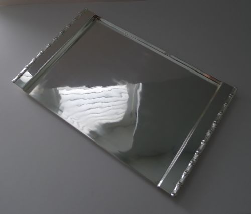 fig 2. A rectangular polished silver-plated tray featuring cast bamboo-style handles along two opposite ends.