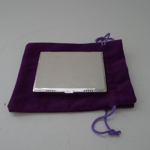 fig 1. A low-profile rectangular sterling silver box with a hinged lid, polished reflective finish, and subtle beaded accents along the rim.