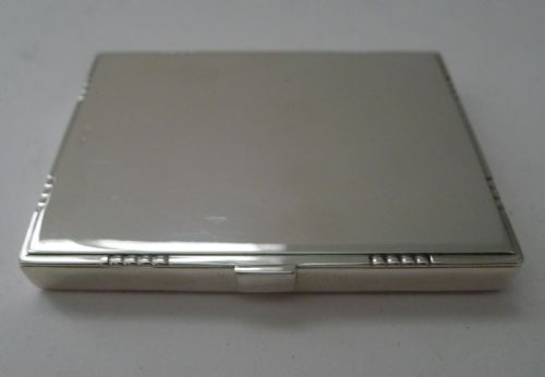 fig 2. A low-profile rectangular sterling silver box with a hinged lid, polished reflective finish, and subtle beaded accents along the rim.