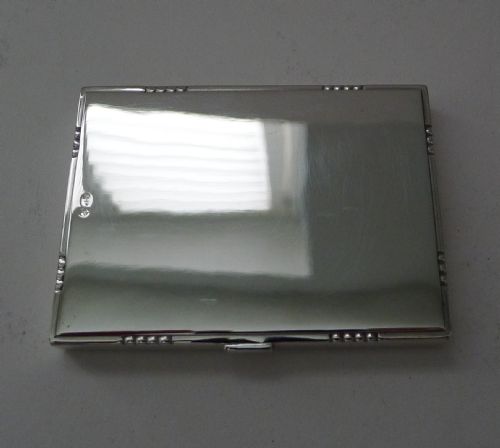 fig 3. A low-profile rectangular sterling silver box with a hinged lid, polished reflective finish, and subtle beaded accents along the rim.