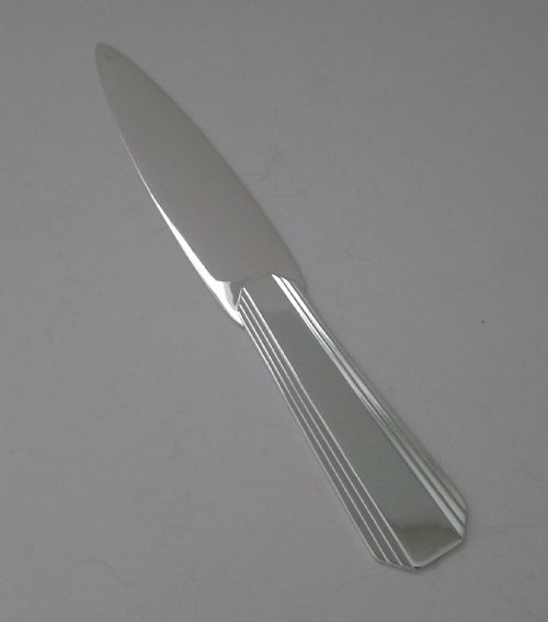 fig 1. A silver-plated Art Deco paper knife with a fluted geometric handle and smooth tapered blade.