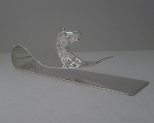 fig 1. A polished silver-plated bent metal desk clip featuring a detailed sculpted horse head motif.