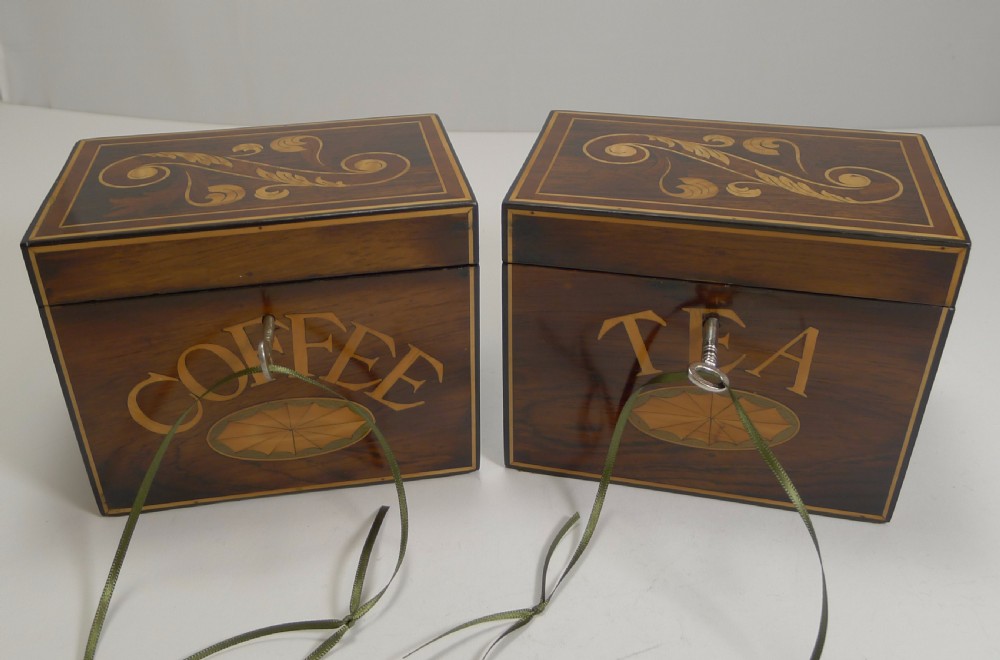 A pair of dark wood Victorian tea and coffee caddies featuring scroll marquetry on the lids and inlaid lettering on the front. View IX