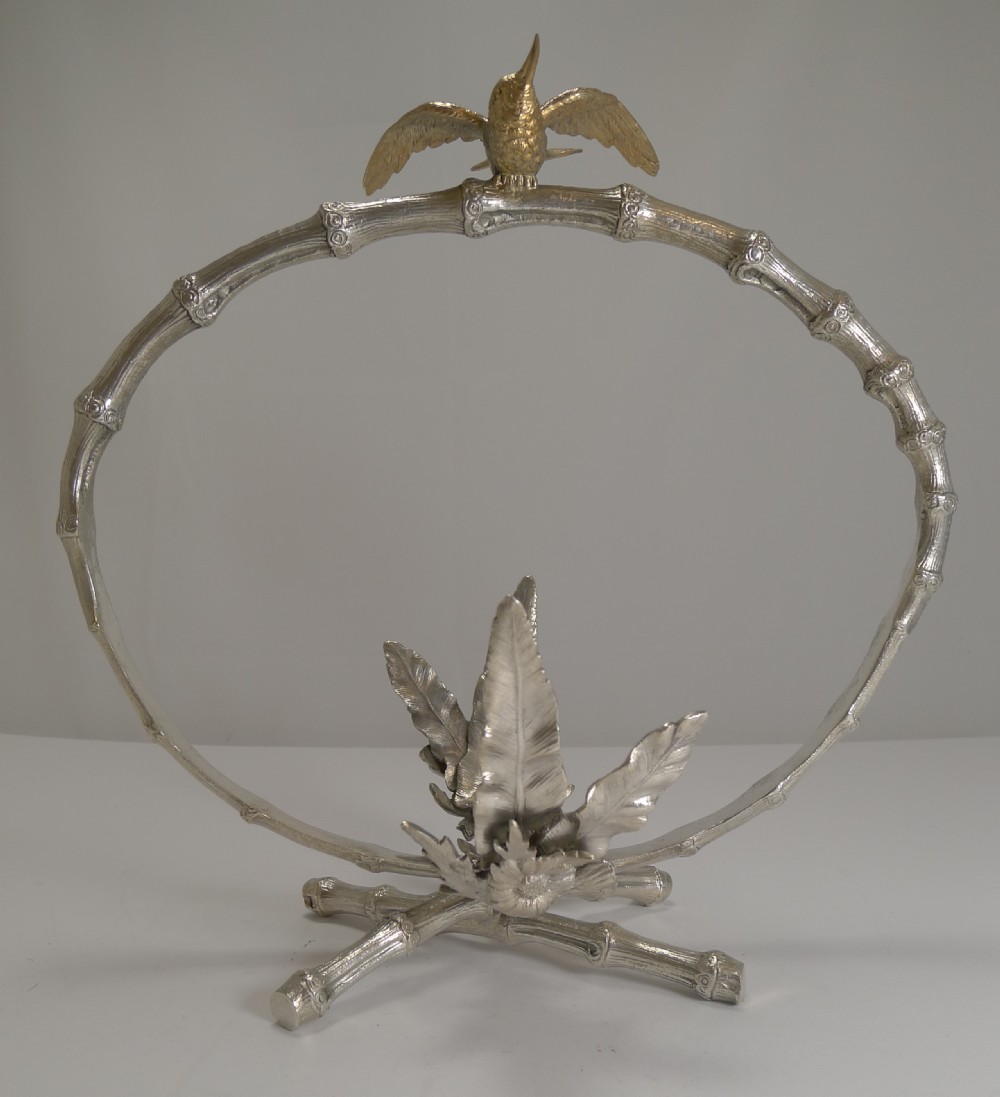 A Victorian cut crystal dish resting inside a silver-plated frame featuring an arched faux-bamboo handle with a small bird finial and a crossed-bamboo base. View V