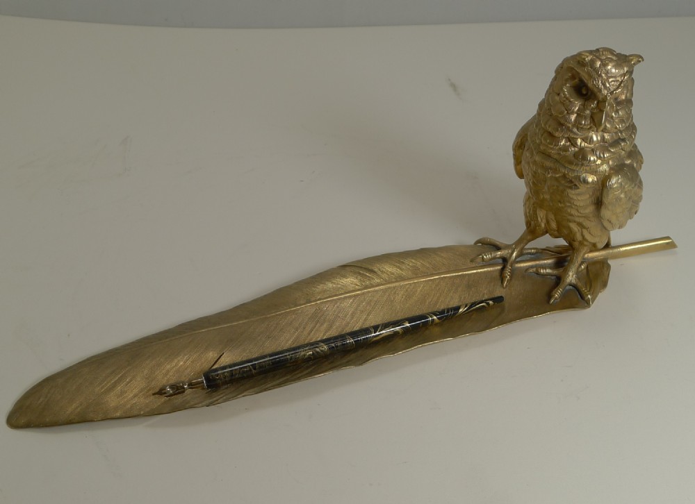 A gilded bronze inkwell modelled as an owl perched upon a detailed feather-shaped pen tray. View XIII