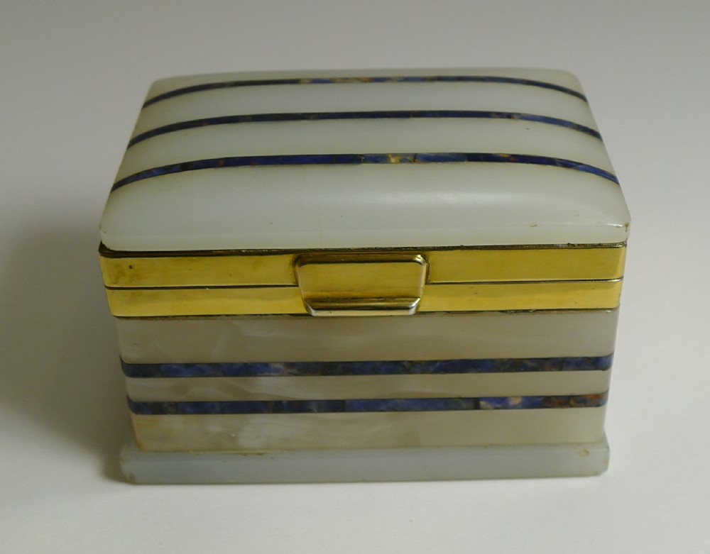 A small rectangular white onyx table box featuring inlaid blue lapis lazuli horizontal stripes and a gilded metal rim clasp.