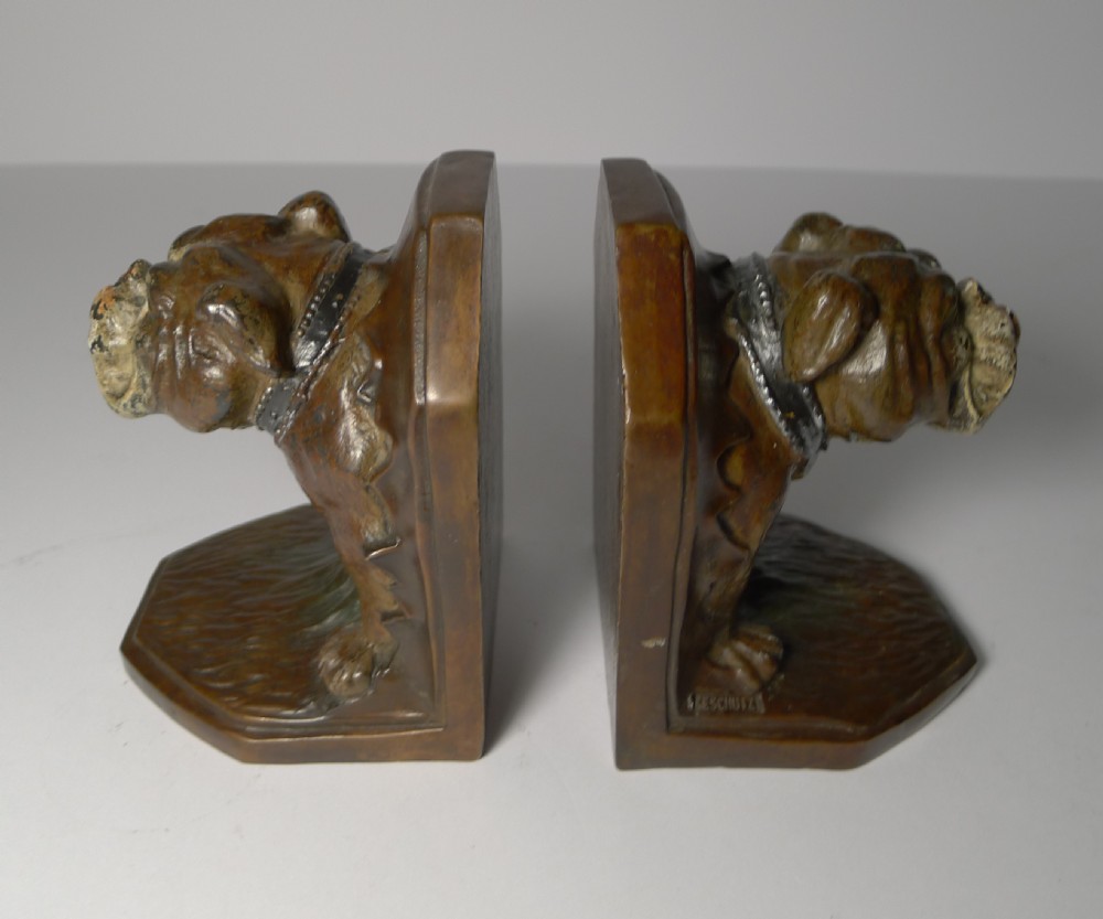 A pair of brown cold-painted bronze bookends featuring sculpted English bulldog heads and forelegs set against angled backplates. View III