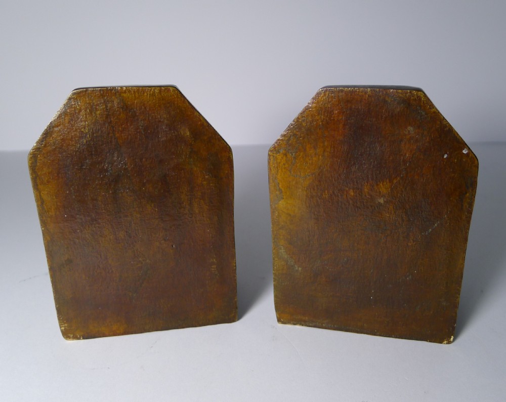 A pair of brown cold-painted bronze bookends featuring sculpted English bulldog heads and forelegs set against angled backplates. View V